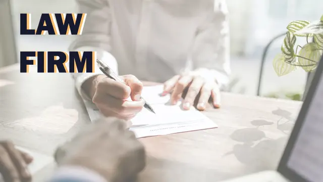 Law Firm — a lawyer signing a document across a desk from a client