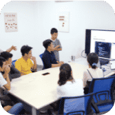 Team members working around a shared desk in the office